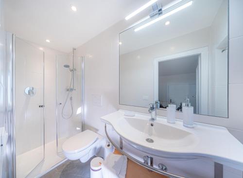 a bathroom with a sink and a toilet and a shower at Villa Suredl in Ortisei