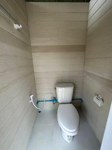 a small bathroom with a toilet in a room at Rabbit Bungalow in Ko Phayam