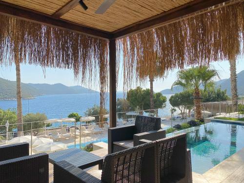 a resort with a swimming pool and a view of the ocean at Kas Marin Hotel in Kas