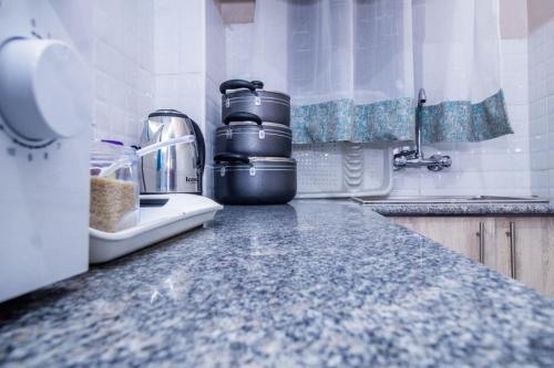 a kitchen counter with a coffee maker on it at Nairobi Best Apartment Stay in Nairobi