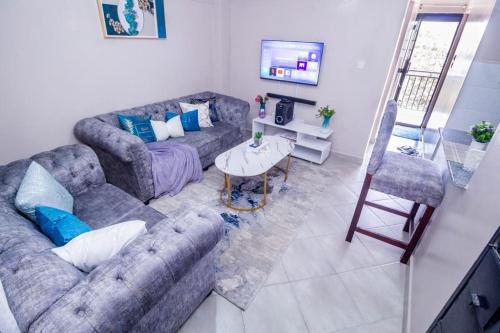 a living room with a couch and a table at Nairobi Best Apartment Stay in Nairobi