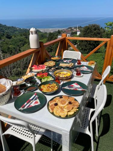 a table filled with plates of food on top at Green Luxury Bungalovs in Pazar