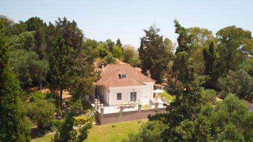 Elegant Villa Zakynthos في كالاماكي: اطلالة جوية على بيت ابيض فيه اشجار