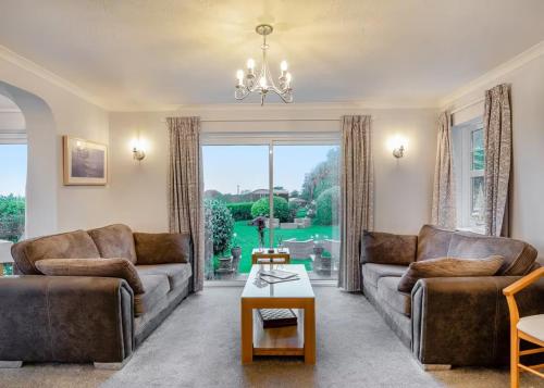 a living room with two couches and a table at Beacon Country House Hotel & Luxury Shepherd Huts in St. Agnes 
