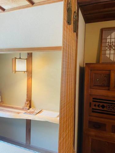 a room with a bed and a wooden cabinet at えん飛鳥　日本始まりの地　古民家一棟貸し　8人＋大型犬も宿泊可能 in Asuka