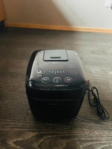 a black electronic device sitting on a wooden floor at えん飛鳥　日本始まりの地　古民家一棟貸し　8人＋大型犬も宿泊可能 in Asuka