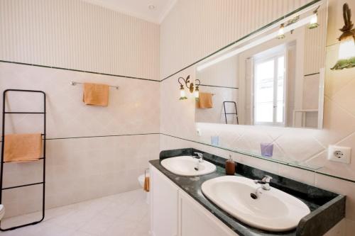 a bathroom with two sinks and a mirror at PALACIO DON CARLOS in Jerez de la Frontera