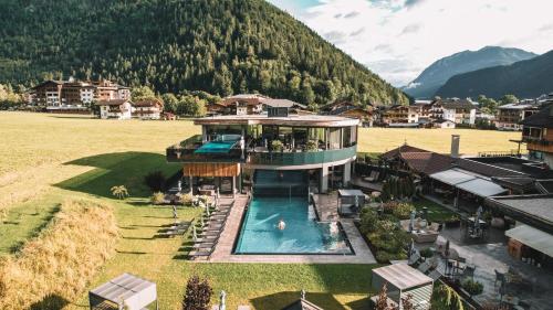 an aerial view of a house with a swimming pool at Hotel Wagnerhof in Pertisau