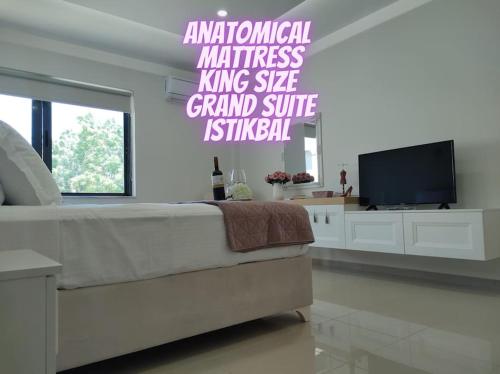 a bedroom with a bed and a flat screen tv at Luxury apartment in the heart of the city in Chania Town
