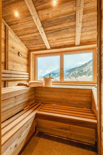 a sauna with a window in a wooden cabin at Apartmenthaus Wiesenhof in Aschau
