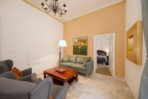 a living room with two couches and a table at PALACIO DON CARLOS in Jerez de la Frontera