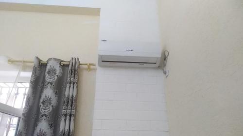 a bathroom with a heater and a curtain at Двухуровневая квартира студия - Duplex studio apartment in Dushanbe
