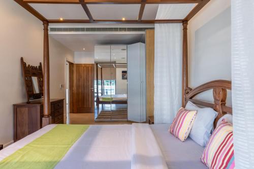 um quarto com uma cama grande e uma cabeceira em madeira em English Point Marina Luxe C405 em Mombaça