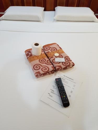 a remote control sitting on top of a table at Marianita's cottages in Mambajao