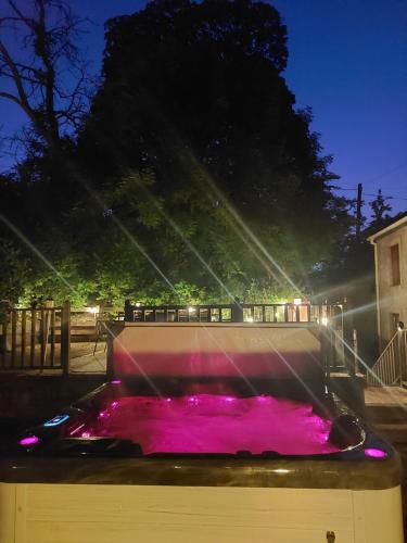 a pool of pink water in a fountain at night at Ballywee guest house in Parkgate