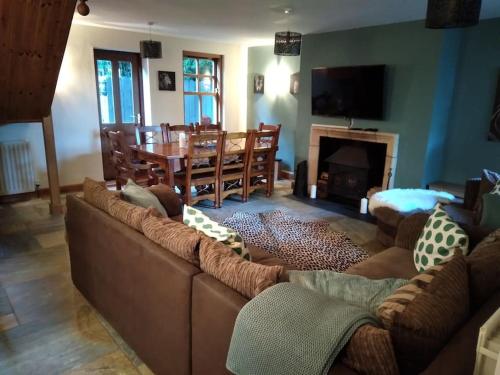 a living room with a couch and a dining room at Ballywee guest house in Parkgate