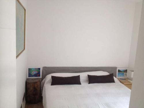 a bedroom with a large white bed with two pillows at Stunning & Modern Penthouse - Rambla - City centre in Tarragona
