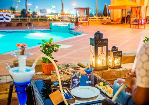 een tafel met eten en drinken naast een zwembad bij Ramses Hilton Hotel & Casino in Caïro