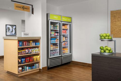 a refrigerator in a store with food and drinks at Home2 Suites by Hilton Austin Round Rock in Round Rock