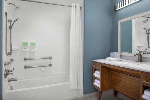 a bathroom with a tub and a sink and a shower at Home2 Suites by Hilton Austin Round Rock in Round Rock