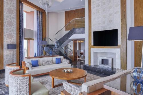 a living room with a couch and a fireplace at Ramses Hilton Hotel & Casino in Cairo