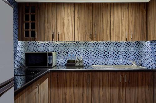 a kitchen with a sink and a stove and a microwave at Ramses Hilton Hotel & Casino in Cairo