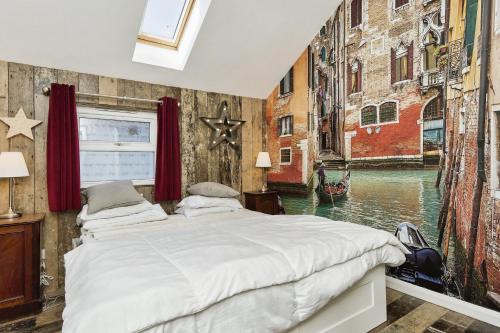 a bedroom with a bed and a canal mural at 28 Marsh Road in Gurnard