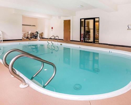 a large swimming pool in the middle of a building at Comfort Inn & Suites near Tinley Park Amphitheater in Tinley Park