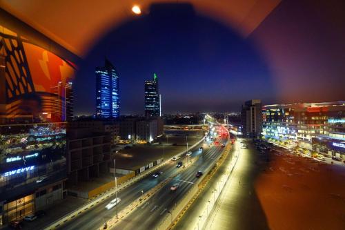 a view of a city at night with traffic at Ramada Encore Al Khobar Corniche in Al Khobar