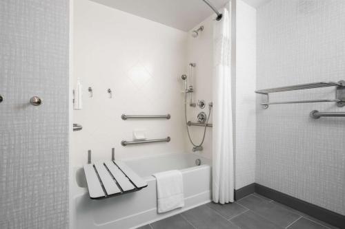 a bathroom with a tub and a toilet and a shower at Hampton Inn & Suites - Cape Cod / West Yarmouth in West Yarmouth