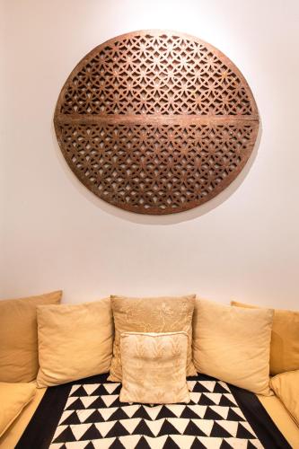a living room with a couch with a wooden ceiling at 55TG Boutique Suites in Colombo