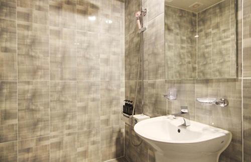 a bathroom with a sink and a toilet at Hotel YOU in Yeosu