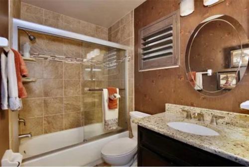 a bathroom with a sink and a toilet and a shower at Island 1 in Kissimmee