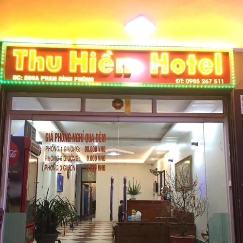 a sign for a hotel in front of a building at Nhà Nghỉ Thu Hiền in Lao Cai