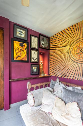 a bedroom with a purple wall with a bed in it at 55TG Boutique Suites in Colombo