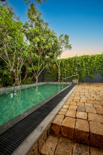 an infinity pool in a villa with trees at 55TG Boutique Suites in Colombo