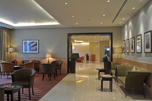 a lobby of a hotel with chairs and tables at DoubleTree by Hilton Hotel London - Marble Arch in London