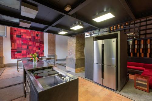 a kitchen with a stainless steel refrigerator in a room at Santa Cecilia Loft in Rome