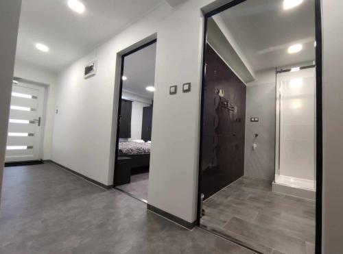 a large mirror in a room with a bedroom at Theresa Vendégház in Kiskunmajsa