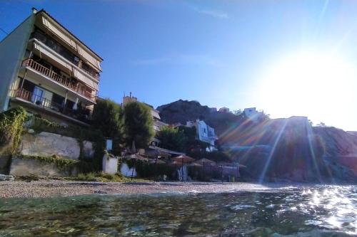 a building on the shore of a beach at Als Plomari - Sea View Apartment in Plomarion