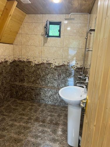 ein Bad mit einem Waschbecken und einem Fenster in der Unterkunft Cozy Cottage Dilijan Arm in Dilidschan