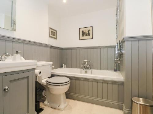 a bathroom with a tub and a toilet and a sink at Kestrel in Malpas