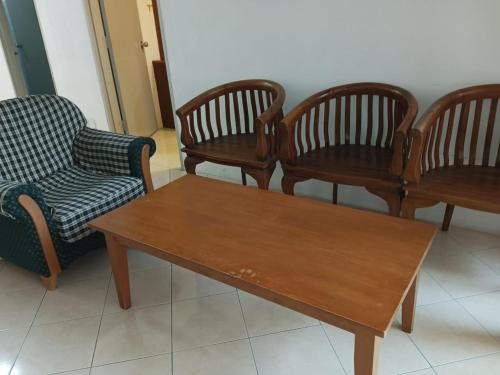 a group of chairs and a wooden coffee table at My Getaway Home @Marina Cove in Lumut