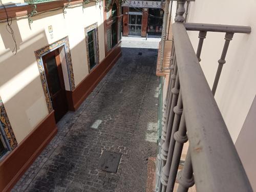 an empty alleyway in a building with a railing at Apartamentos Luxury Puente de Triana in Seville