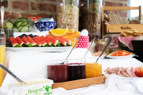 a buffet with fruit and other foods on a table at Kvibergs Vandrarhem - Hostel in Gothenburg