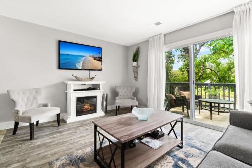 a living room with a fireplace and a tv at Condo at the Lakes in Charleston