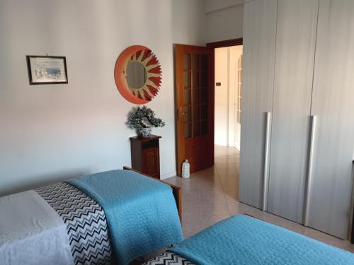a bedroom with a bed and a mirror on the wall at Relax al mare in Borgio Verezzi