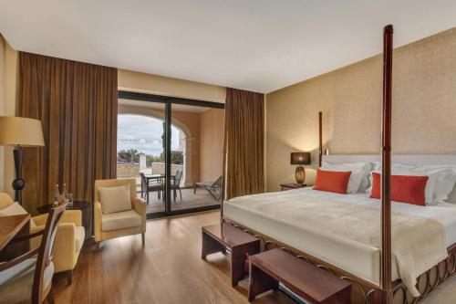 a hotel room with a bed and a desk and a chair at Cascade Wellness Resort in Lagos