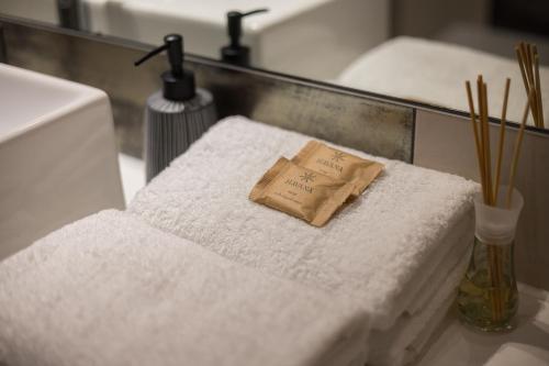 a bathroom with two white towels and a napkin at Arena Ursynów Luxury Apartment in Warsaw