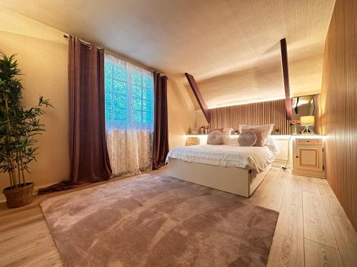 une chambre avec un lit et une grande fenêtre dans l'établissement Villa avec pièce Billard style Ranch US, à Saint-Fargeau-Ponthierry